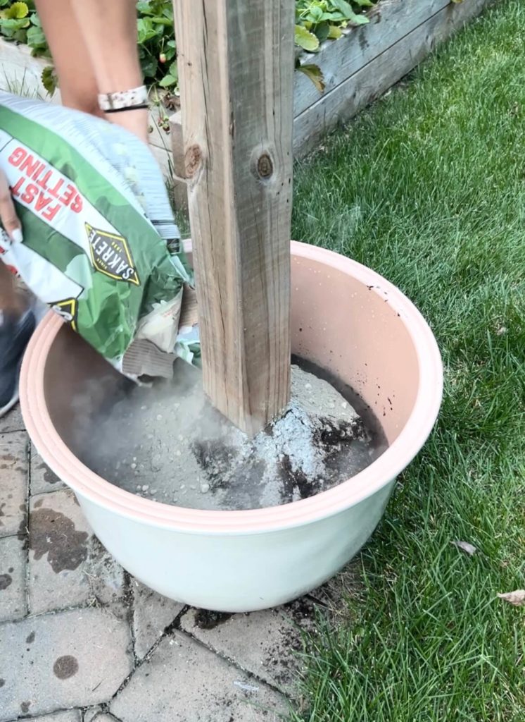 Pouring cement mix into planter