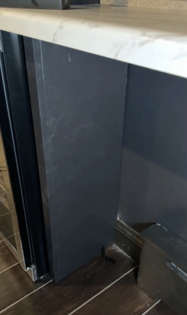 Vertical plywood under the faux marble counter. 